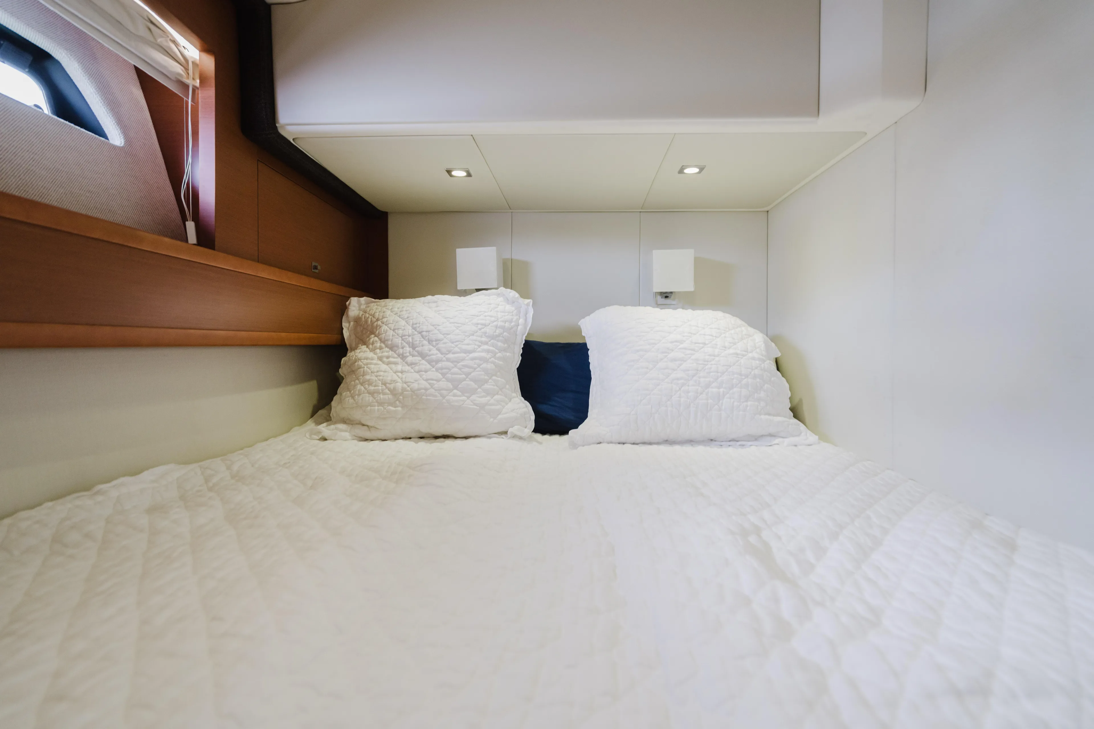 Worldwide Yacht Photos Pics Cozy bedroom in 2014 Prestige 620 Fly yacht with white bedding and pillows.