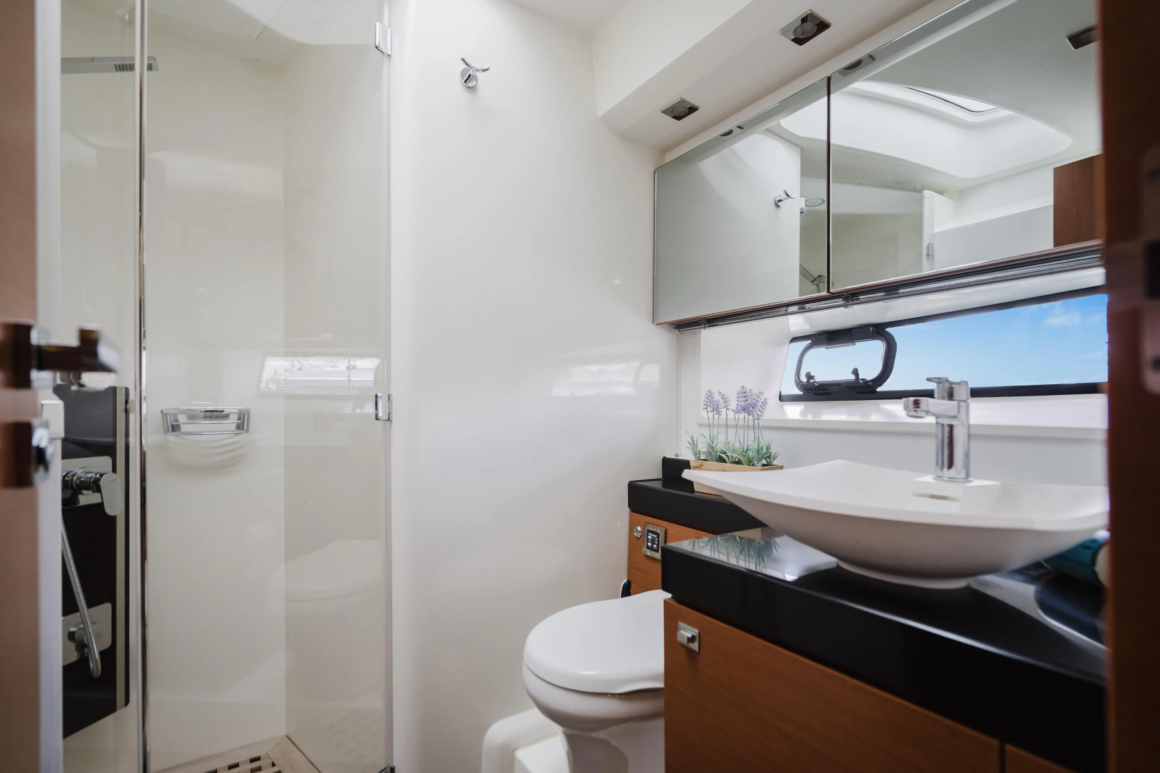 Worldwide Yacht Photos Pics Luxurious bathroom in 2014 Prestige 620 Fly yacht with modern fixtures and sleek design.