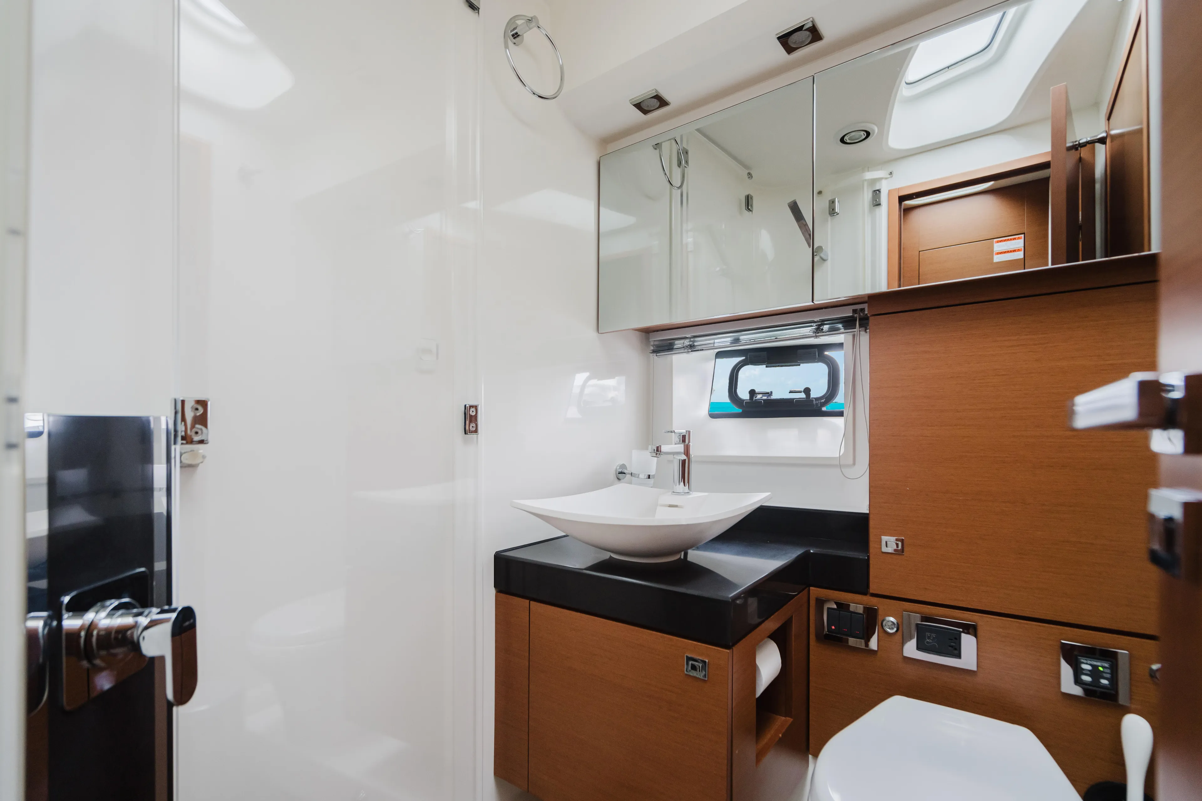 Worldwide Yacht Photos Pics Luxurious bathroom interior of 2014 Prestige 620 Fly yacht with modern fixtures and wood accents.