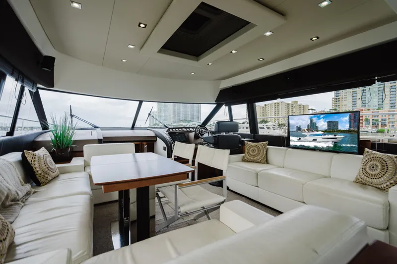 Worldwide Yacht Photos Pics Luxurious interior of 2014 Prestige 620 Fly yacht with modern seating and cityscape view.