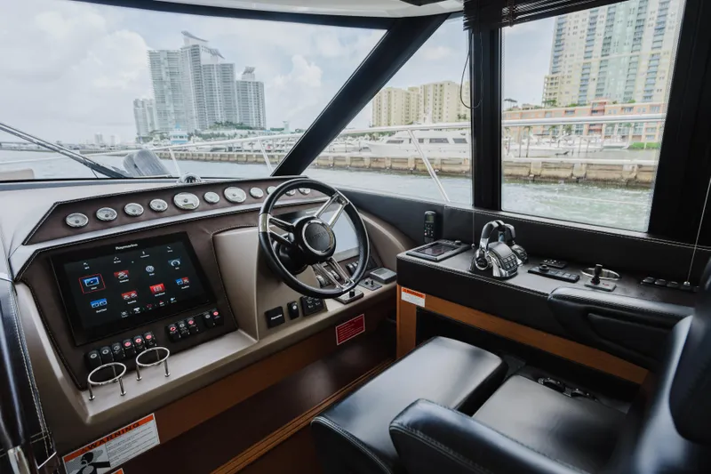 Worldwide Yacht Photos Pics Interior helm of 2014 Prestige 620 Fly yacht with modern controls and waterfront view.