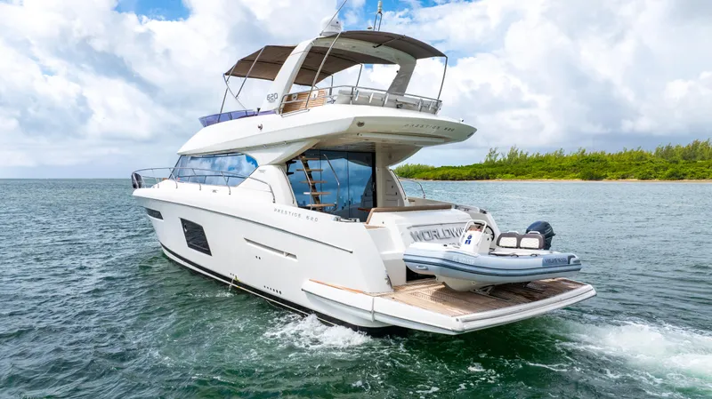 Worldwide Yacht Photos Pics Prestige 620 Fly 2014 yacht cruising on open water under a cloudy sky.