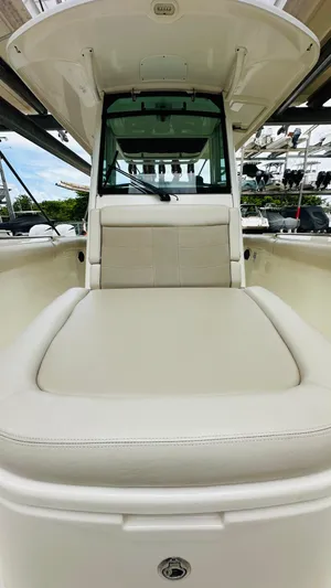  Yacht Photos Pics 2020 Boston Whaler 330 Outrage boat with cushioned seating and sleek design.