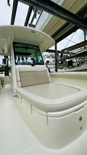  Yacht Photos Pics 2020 Boston Whaler 330 Outrage boat with cushioned seating and sleek design.