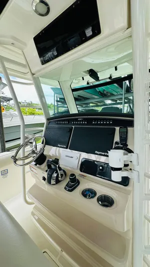  Yacht Photos Pics 2020 Boston Whaler 330 Outrage helm with advanced navigation and control systems.