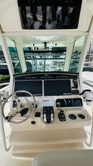  Yacht Photos Pics 2020 Boston Whaler 330 Outrage helm with steering wheel and navigation controls.