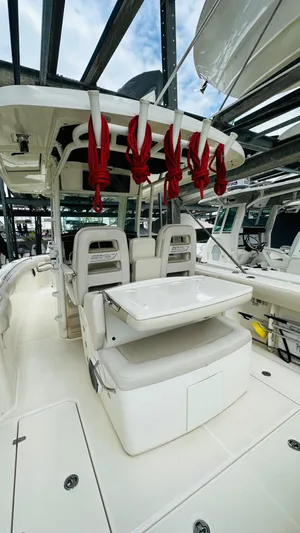  Yacht Photos Pics 2020 Boston Whaler 330 Outrage boat interior with seating and fishing rod holders.