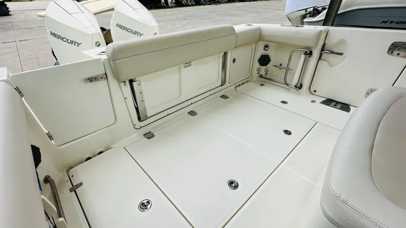  Yacht Photos Pics 2020 Boston Whaler 330 Outrage boat deck with Mercury engines, featuring spacious seating and storage.