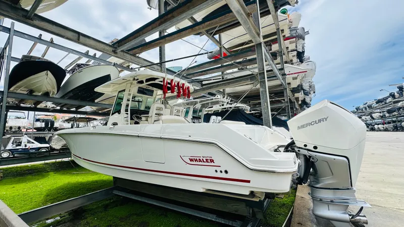  Yacht Photos Pics 2020 Boston Whaler 330 Outrage boat in storage, featuring Mercury outboard engines.
