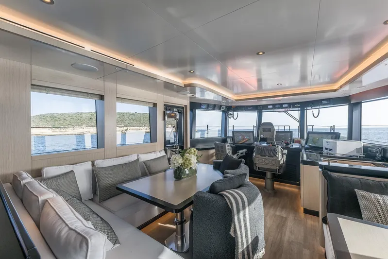 Vanguard Yacht Photos Pics Luxurious interior of 2023 Naval Yachts XPM 78 with modern seating and navigation area.