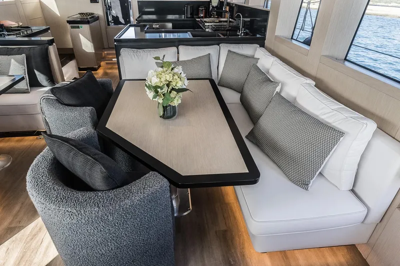 Vanguard Yacht Photos Pics Luxurious interior of 2023 Naval Yachts XPM 78 with elegant seating and dining area.