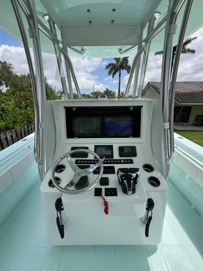  Yacht Photos Pics 2024 Contender 35 ST boat console with steering wheel and navigation system.