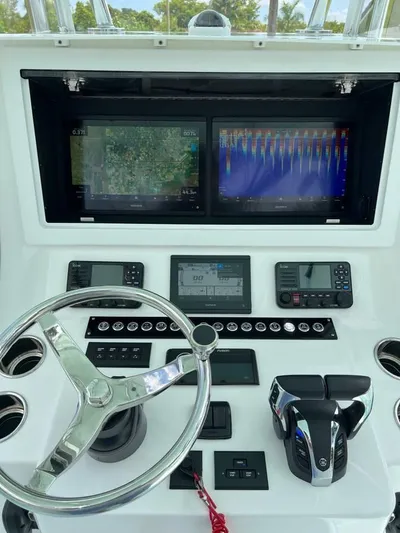  Yacht Photos Pics 2024 Contender 35 ST boat dashboard with dual screens and steering wheel.