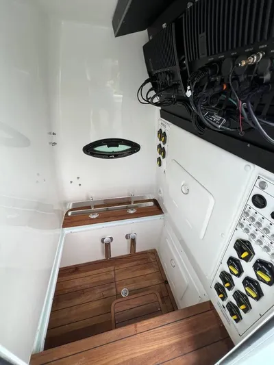 Yacht Photos Pics 2024 Contender 35 ST interior with wood flooring and control panels.
