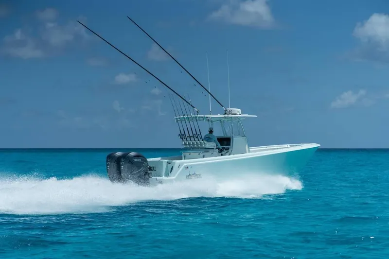  Yacht Photos Pics 2024 Contender 35 ST boat speeding on clear blue ocean water.