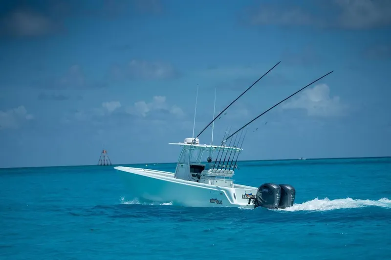  Yacht Photos Pics 2024 Contender 35 ST boat cruising on clear blue ocean waters.