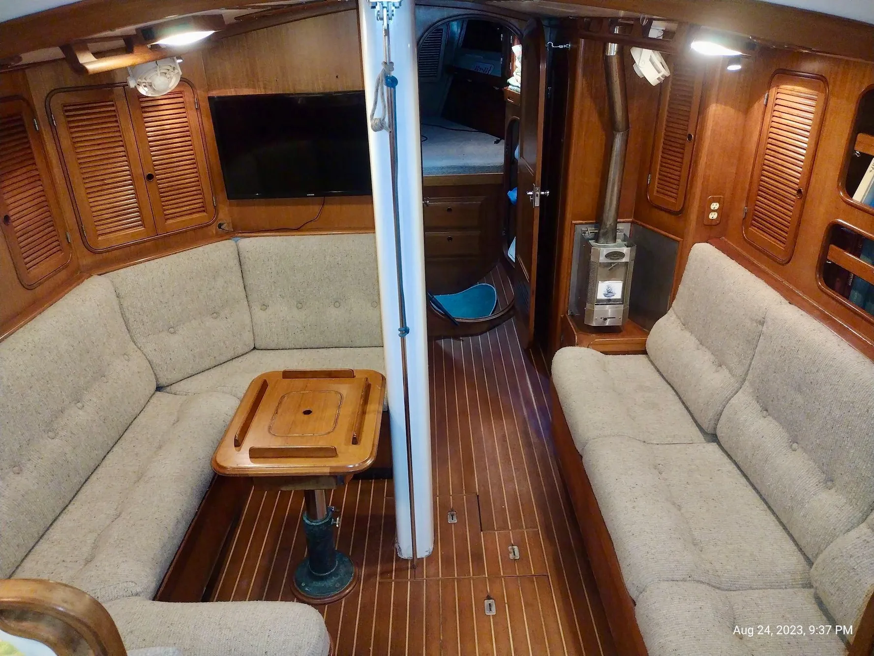 Interior of 1983 Norseman 447 CC Cutter with cozy seating and wooden finishes.