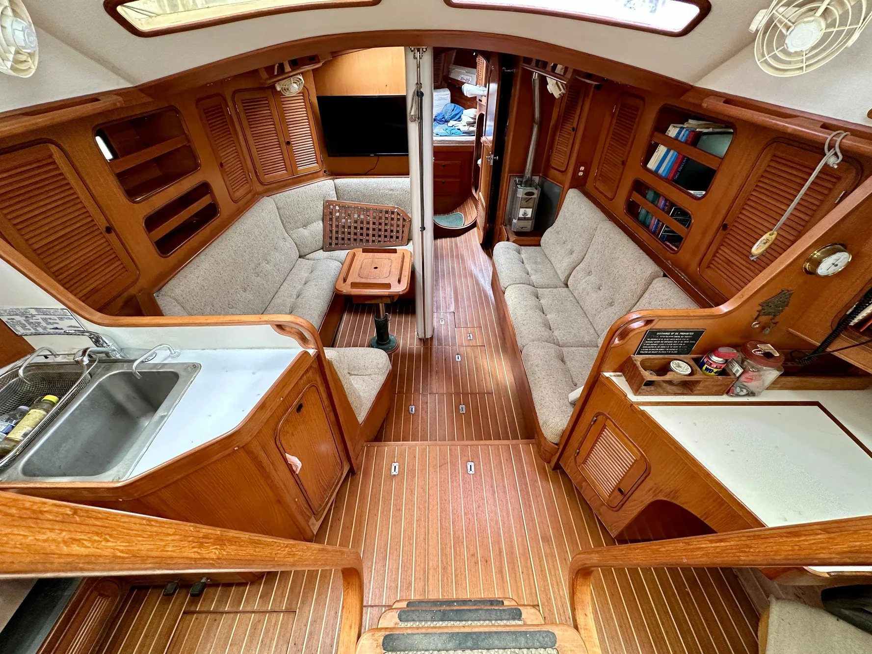 Interior of 1983 Norseman 447 CC Cutter, featuring wood paneling and cozy seating.