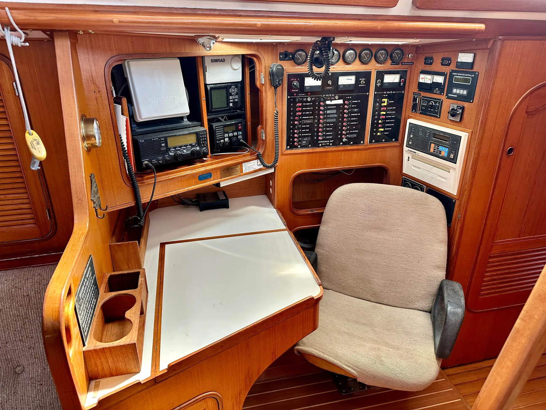 Navigation station of 1983 Norseman 447 CC Cutter with control panels and equipment.