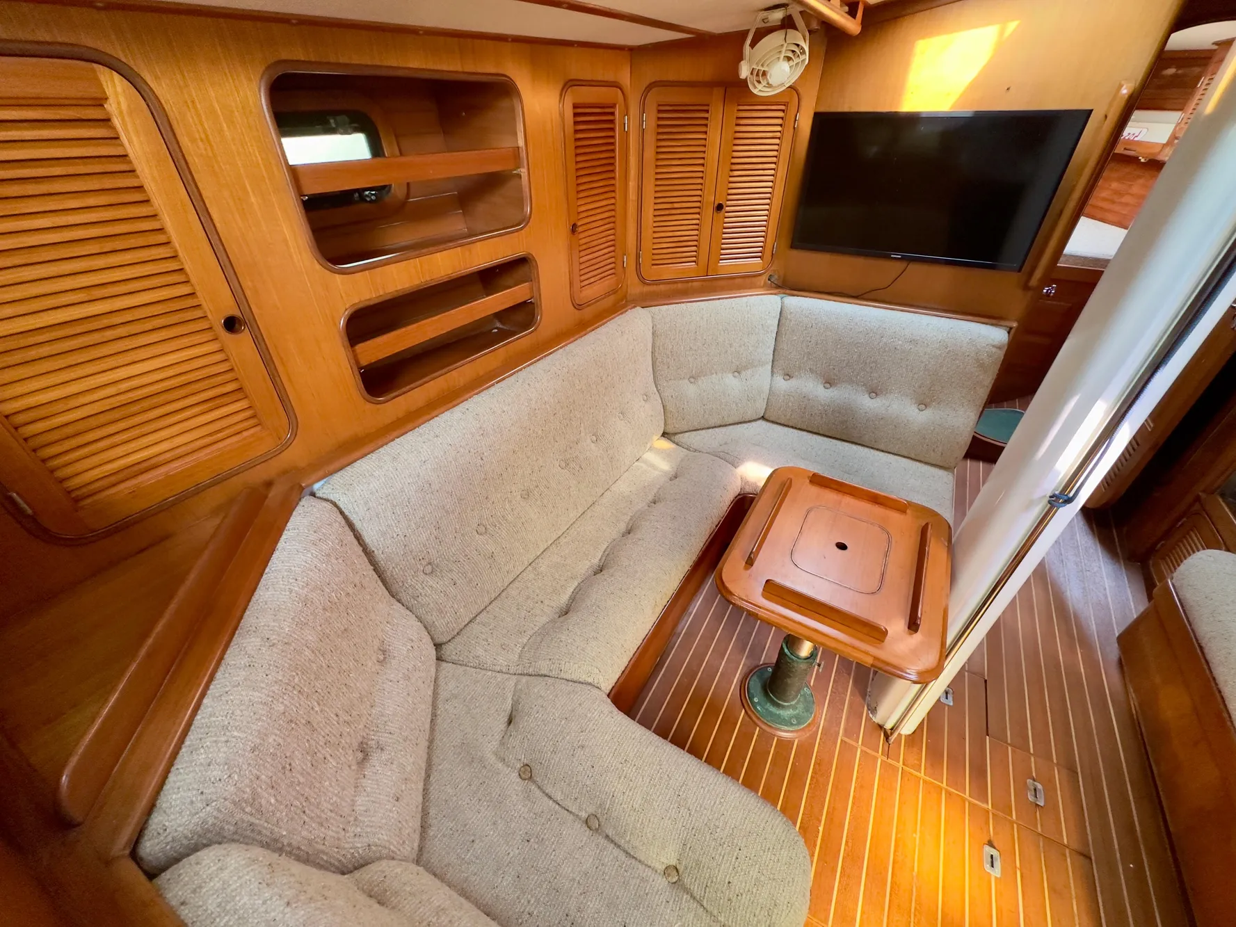 Interior of 1983 Norseman 447 CC Cutter with cozy seating and wooden finishes.