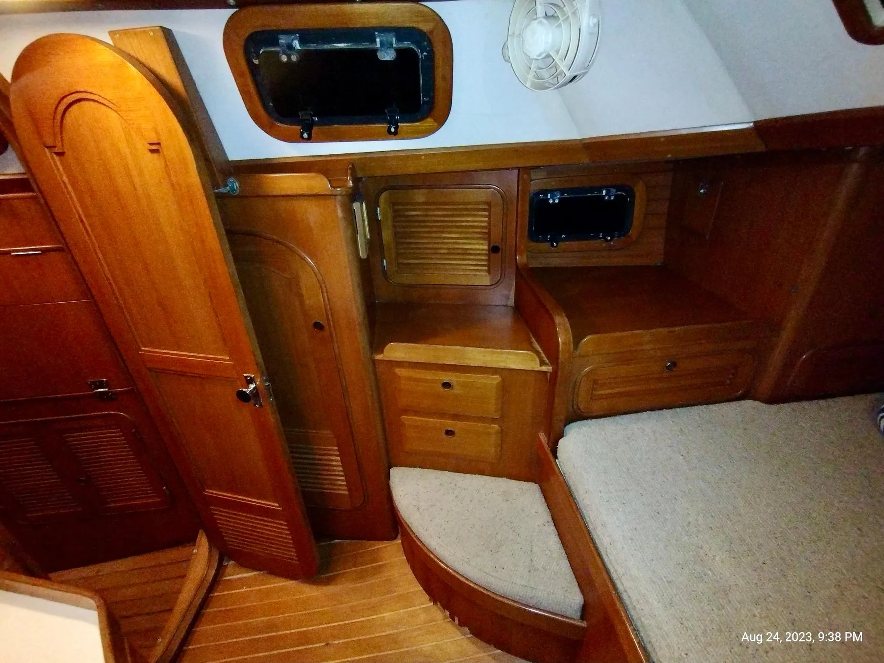 Interior of 1983 Norseman 447 CC Cutter, featuring wooden cabinetry and cozy seating area.