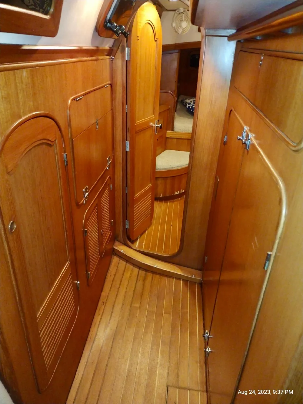 Interior of 1983 Norseman 447 CC Cutter with wooden cabinetry and flooring.