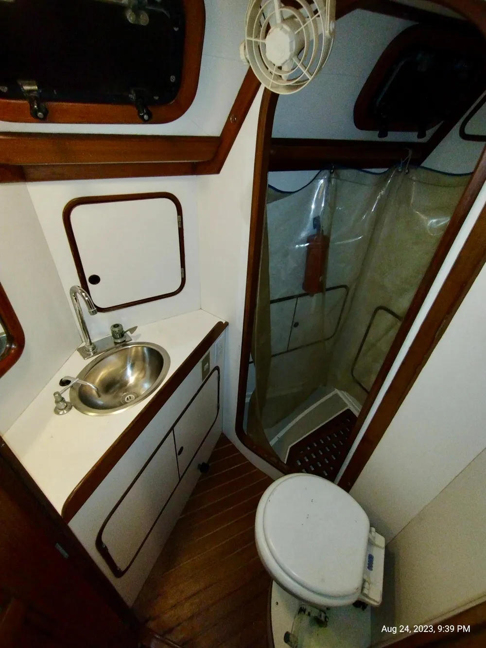 1983 Norseman 447 CC Cutter bathroom with sink, toilet, and shower.