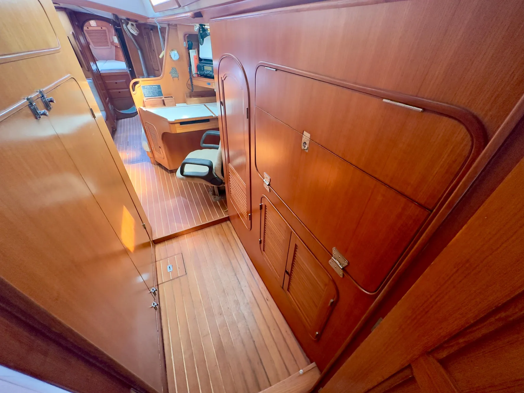Interior of 1983 Norseman 447 CC Cutter, featuring wooden paneling and seating area.