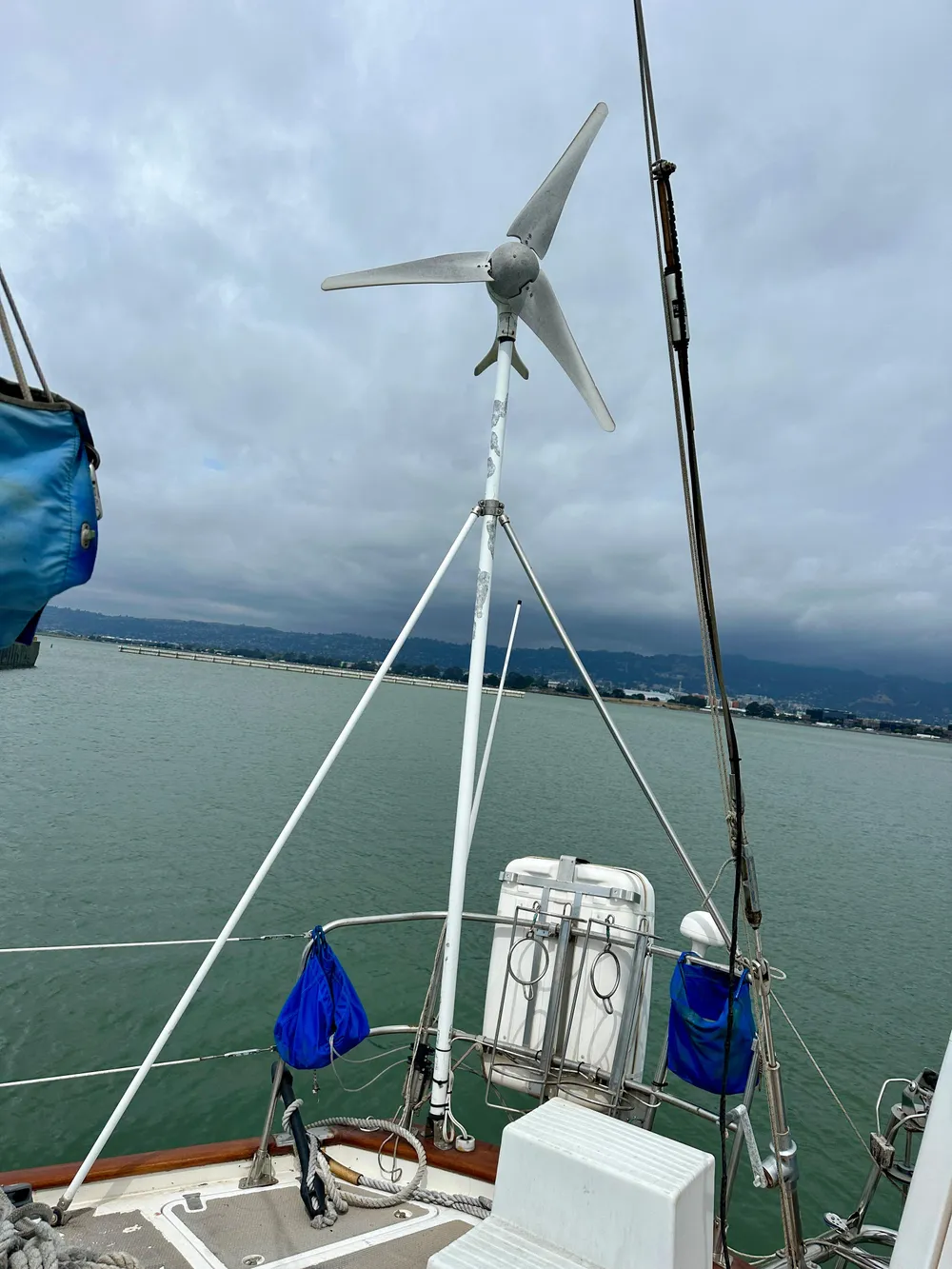 Sailboat deck with wind turbine, Norseman 447 CC Cutter, 1983 model, on a cloudy day.