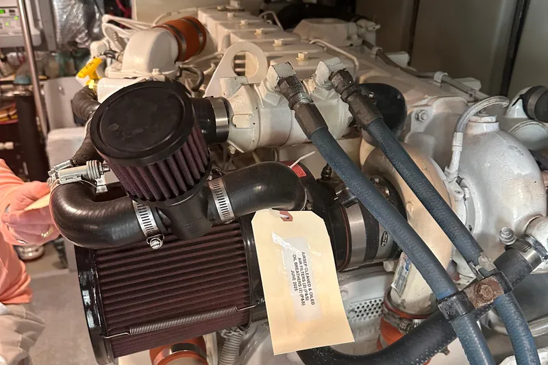 Double Eagle Yacht Photos Pics Engine compartment of a 2004 Silverton 42 Convertible boat, showcasing detailed components.