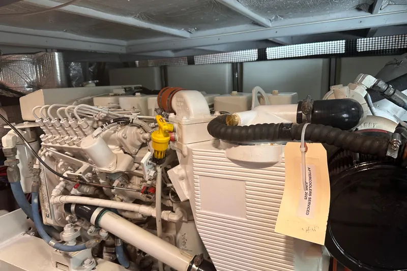 Double Eagle Yacht Photos Pics Engine compartment of a 2004 Silverton 42 Convertible boat, showcasing detailed mechanical components.