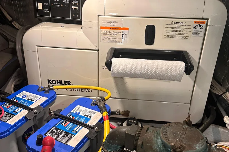 Double Eagle Yacht Photos Pics Engine room of 2004 Silverton 42 Convertible with Kohler power system and batteries.