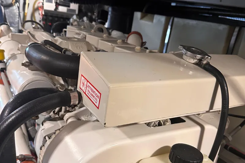 Double Eagle Yacht Photos Pics Engine compartment of a 2004 Silverton 42 Convertible boat, showcasing mechanical components.