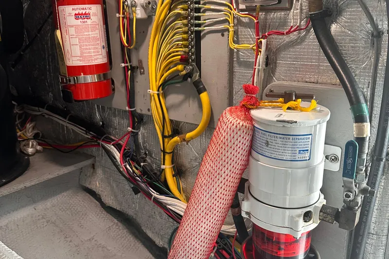 Double Eagle Yacht Photos Pics Engine room of 2004 Silverton 42 Convertible with wiring, fire extinguisher, and fuel filter.