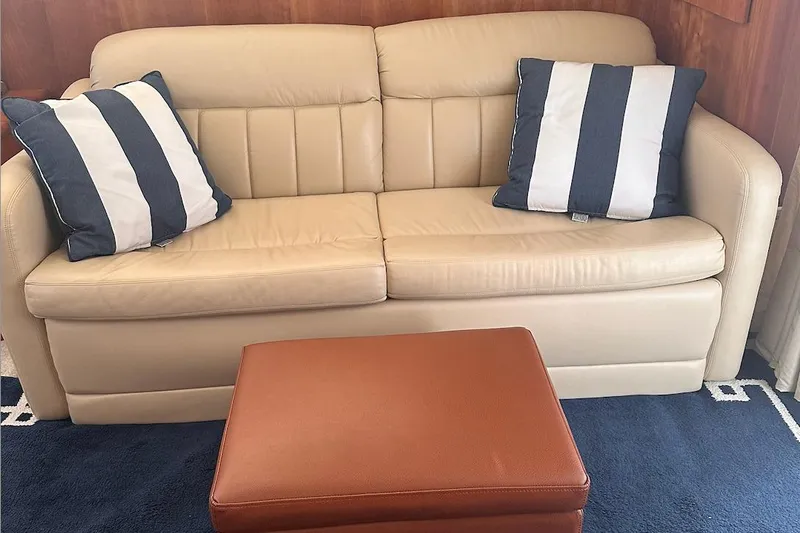 Double Eagle Yacht Photos Pics Beige leather sofa with striped cushions in 2005 Silverton 42 Convertible yacht interior.