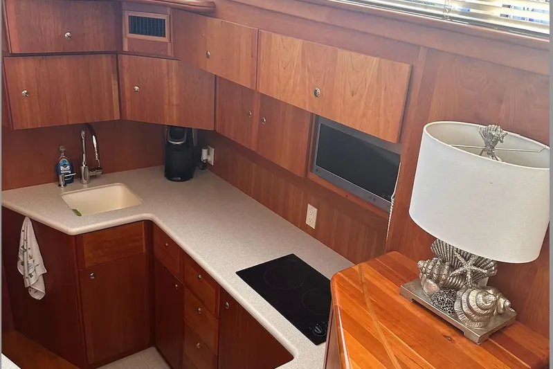 Double Eagle Yacht Photos Pics 2005 Silverton 42 Convertible yacht kitchen with wood cabinets and modern appliances.