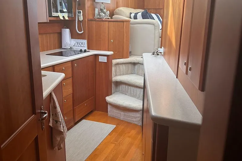 Double Eagle Yacht Photos Pics Interior of 2005 Silverton 42 Convertible yacht with wooden cabinetry and cozy seating area.