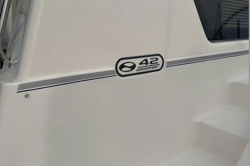 Double Eagle Yacht Photos Pics 2005 Silverton 42 Convertible yacht exterior with model emblem and sleek design.