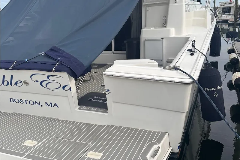 Double Eagle Yacht Photos Pics 2005 Silverton 42 Convertible yacht docked in Boston, MA, with blue cover.