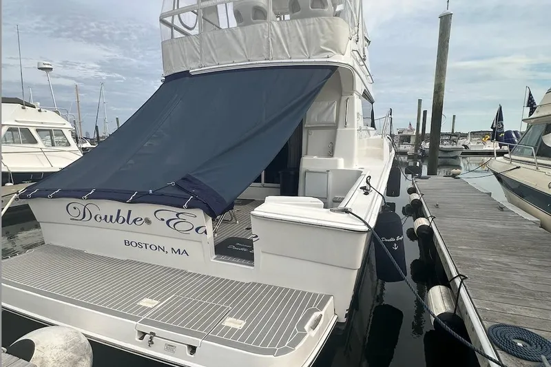 Double Eagle Yacht Photos Pics 2005 Silverton 42 Convertible yacht docked in Boston marina with blue canopy.