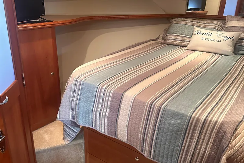 Double Eagle Yacht Photos Pics 2005 Silverton 42 Convertible cabin with striped bedding and cozy decor.