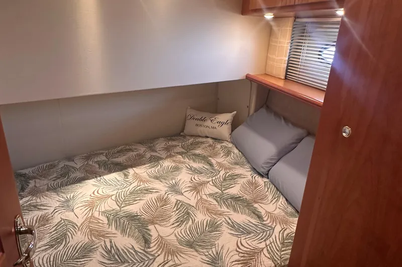Double Eagle Yacht Photos Pics Cozy cabin interior of 2005 Silverton 42 Convertible yacht with leaf-patterned bedding.