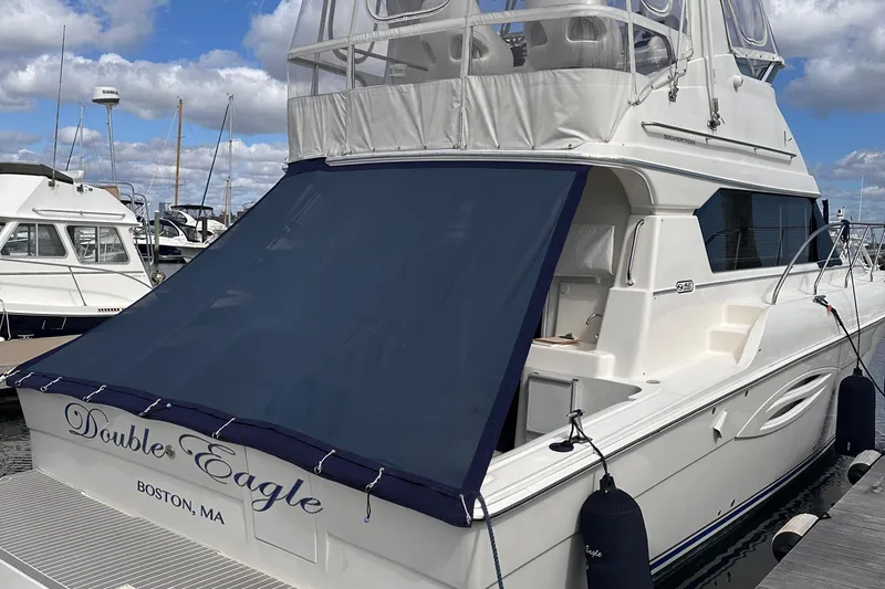 Double Eagle Yacht Photos Pics 2005 Silverton 42 Convertible yacht docked in Boston marina under blue sky.