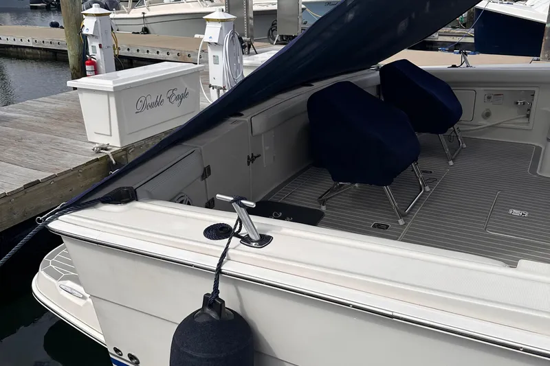 Double Eagle Yacht Photos Pics 2005 Silverton 42 Convertible yacht docked, featuring covered seating and nautical equipment.