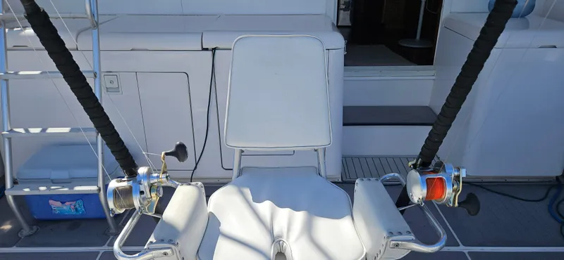 True Grit Yacht Photos Pics Fishing chair with rods on a 1995 Bertram Convertible boat deck.