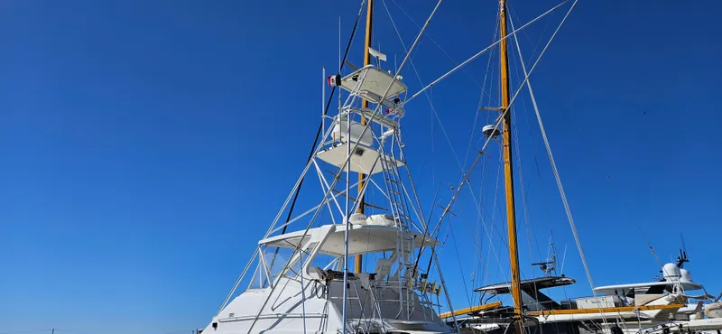 True Grit Yacht Photos Pics 1995 Bertram Convertible yacht with tall tower against clear blue sky.