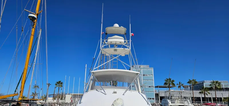 True Grit Yacht Photos Pics 1995 Bertram Convertible yacht docked under clear blue sky.