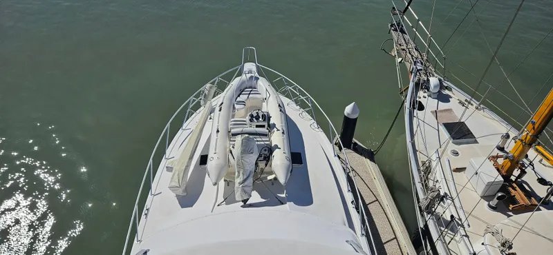True Grit Yacht Photos Pics 1995 Bertram Convertible yacht docked, aerial view of bow with inflatable boat.
