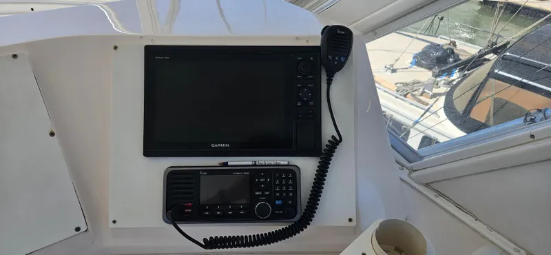 True Grit Yacht Photos Pics 1995 Bertram Convertible boat dashboard with navigation and communication equipment.