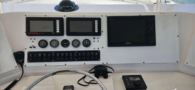 True Grit Yacht Photos Pics Control panel of a 1995 Bertram Convertible boat with navigation instruments and gauges.